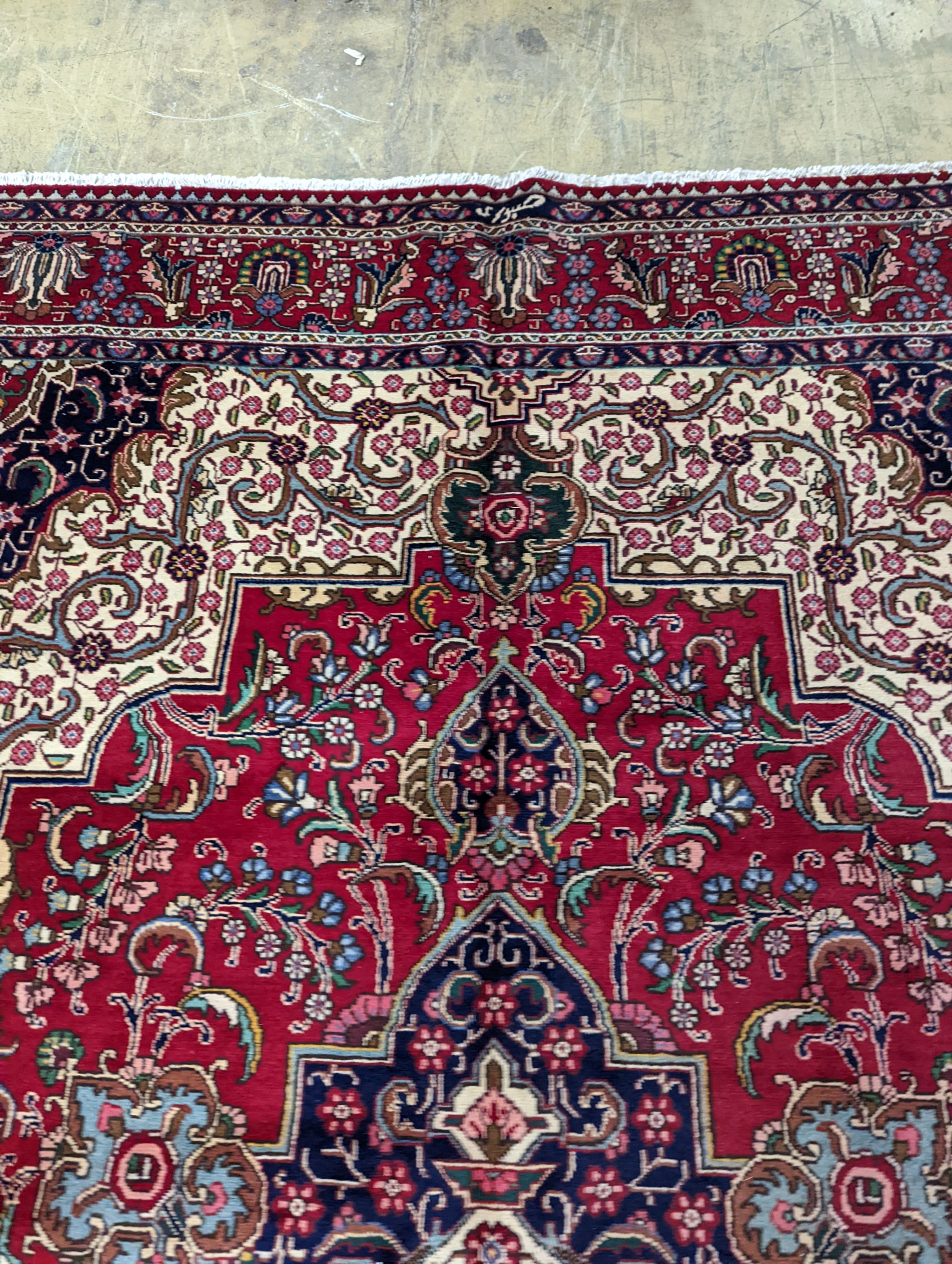 A Tabriz red ground carpet, 405 x 292cm